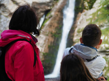 Rear view of mother and teenagers looking at mountain