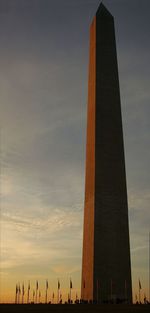 Low angle view of tower against cloudy sky