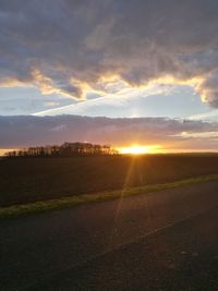 Scenic view of field against sky at sunset