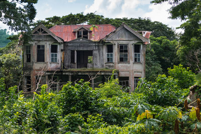 Low angle view of old building in the jungle against sky