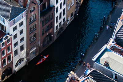 High angle view of boats in canal along buildings