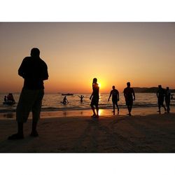 Silhouette of people at sunset