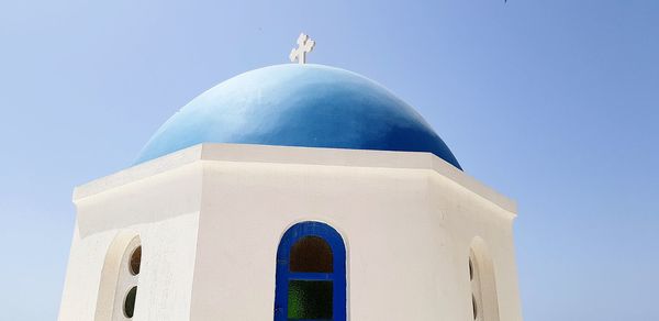 Low angle view of bell tower against clear blue sky