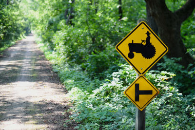 Road sign by trees