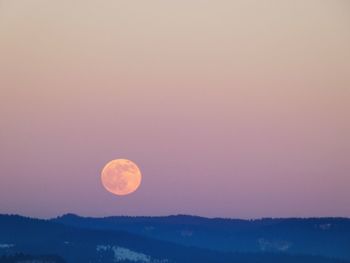 Scenic view of moon against sky at sunset