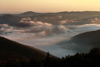 Scenic view of silhouette mountains against sky at sunset