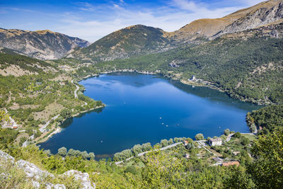 High angle view of sea and mountains against sky