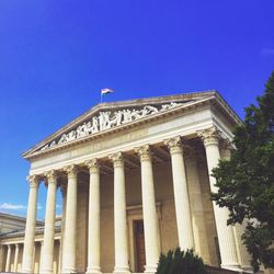 Low angle view of historical building against blue sky