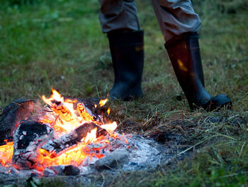 Low section of woman with bonfire