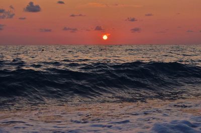 Scenic view of sea against orange sky