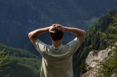 Rear view of woman standing on mountain