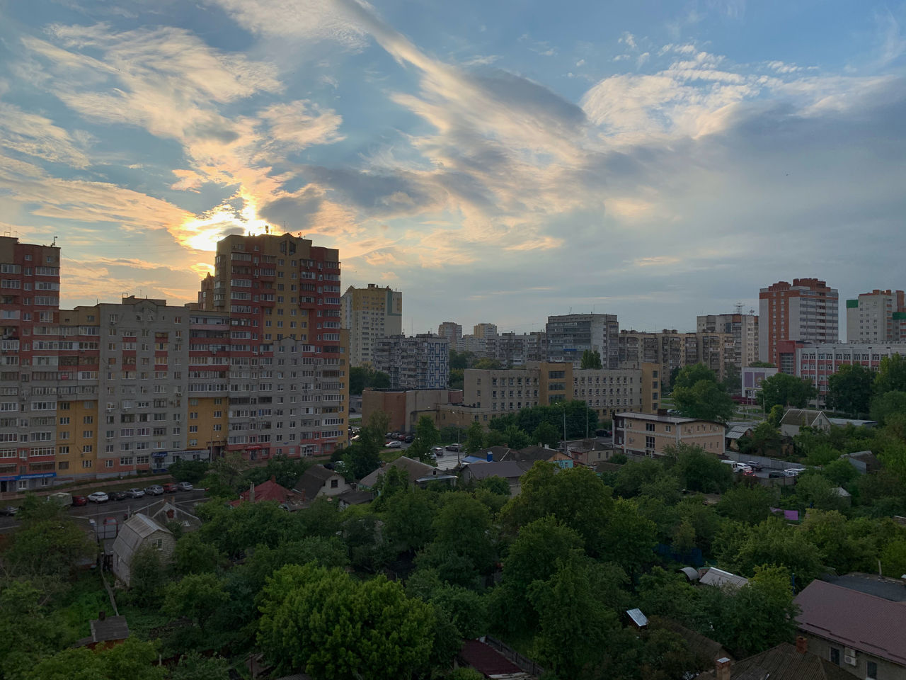 HIGH ANGLE VIEW OF BUILDINGS IN CITY AGAINST SKY AT SUNSET