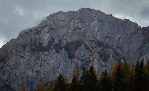 Low angle view of rocky mountains against sky