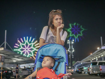 Portrait of happy woman looking away at night