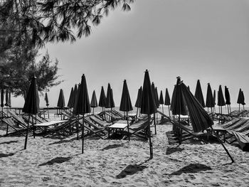 Panoramic view of parasols on beach against clear sky