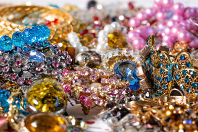 Abstract background from various colorful bright jewelry and costume jewelry, soft, selective focus