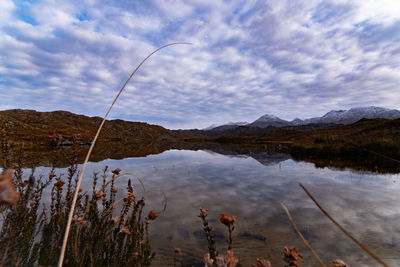 Scenic view of lake and mountains against sky