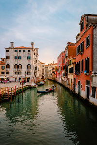 Boats in canal in city