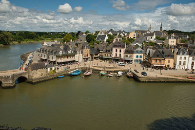 High angle view of townscape by sea against sky