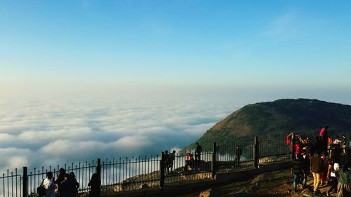 Panoramic view of people on mountain against sky