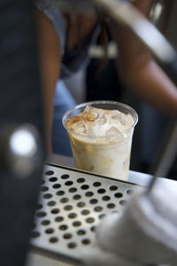 High angle view of iced latte being prepared by barista in a coffee shop in los angeles, ca