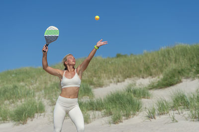 Full length of a young woman standing on land