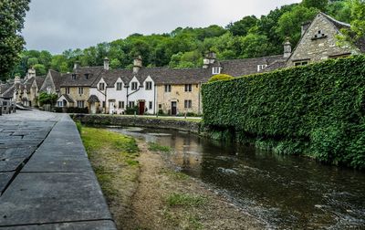 Canal amidst buildings against sky