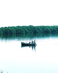 Boat in lake against clear sky