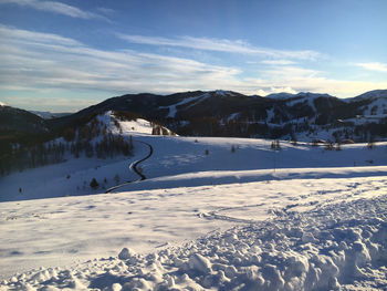 Scenic view of snow covered mountains against sky