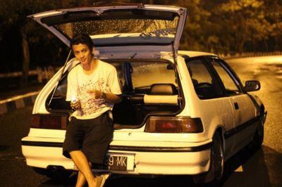 Portrait of woman standing in car