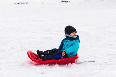 Boy in snow on land