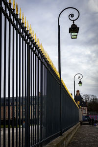 Low angle view of illuminated street light against sky