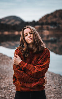 Beautiful young woman standing in snow