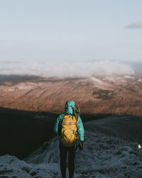 Rear view of man standing on mountain