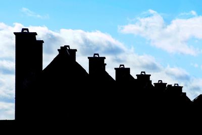 Silhouette of wooden structure against blue sky