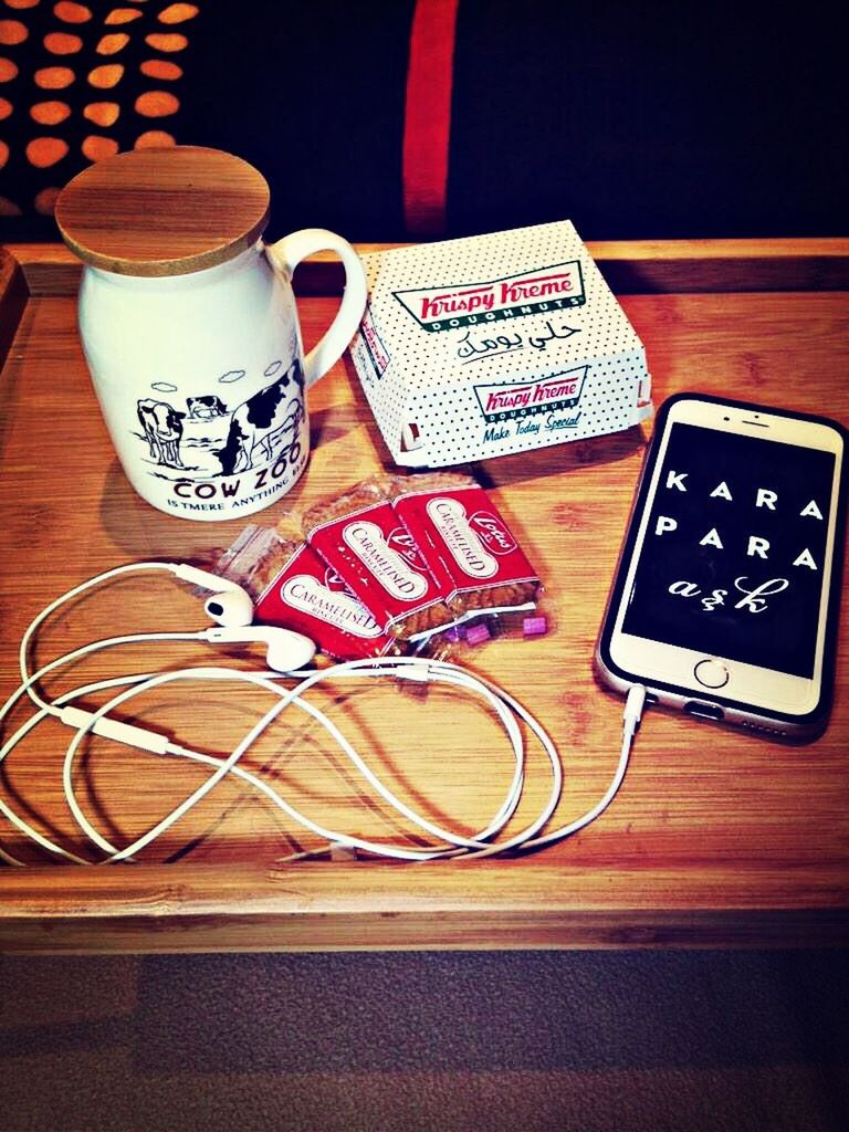 indoors, table, still life, communication, high angle view, book, text, close-up, coffee cup, technology, food and drink, western script, paper, drink, no people, education, wireless technology, cup, connection, wood - material