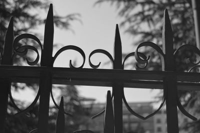 Low angle view of metallic fence