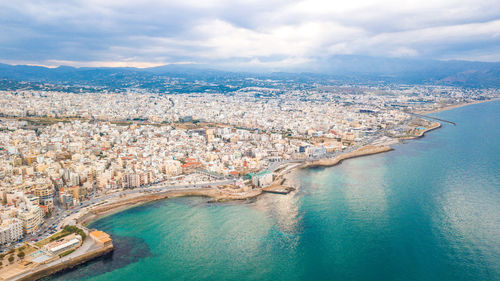 High angle view of city against cloudy sky