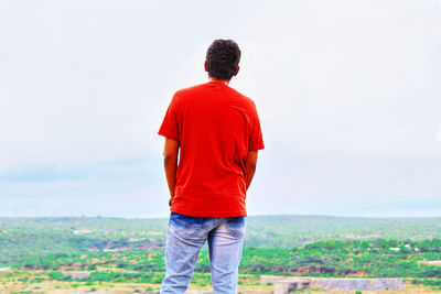 Rear view of man standing on field