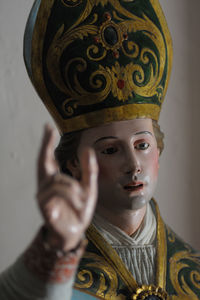 Close-up portrait of man holding cross