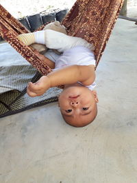 High angle view of cute baby lying on floor