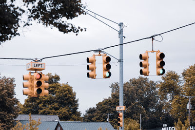 Low angle view of road signal against sky