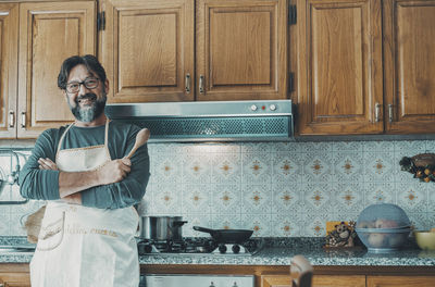 Portrait of man standing in kitchen