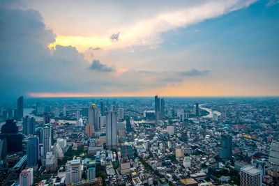 High angle view of modern buildings against sky during sunset