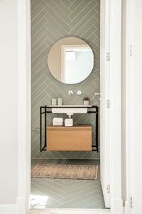 White ceramic sink and toilet near shower and bathtub in modern bathroom with pastel green walls