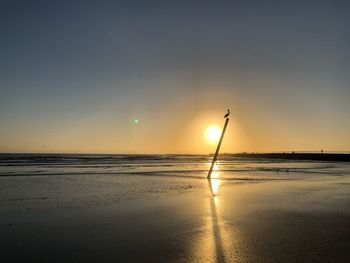 Scenic view of beach against sky during sunset