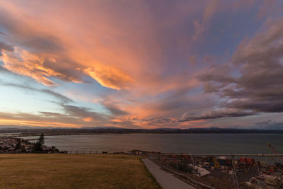 Scenic view of beach against dramatic sky