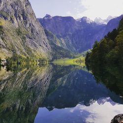 Scenic view of lake and mountains against sky