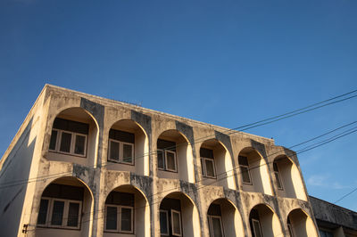 Low angle view of building against clear blue sky