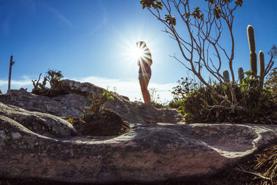 Full length of woman standing on rocks